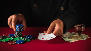 holding casino chips and playing cards